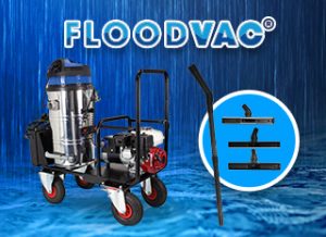 A flood vacuum machine stands on a wet surface, designed for water extraction. Nearby, attachments are displayed in a circular inset. The text "FLOODVAC®" appears above in bold letters.