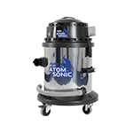 A polished metal vacuum cleaner with a black top labeled "ATOM SONIC" stands on four wheels, featuring various attachments, set against a plain backdrop.
